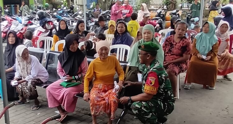 Penuh Senyum, Babinsa Wonokoyo Dampingi 479 KPM Terima Bantuan Pangan